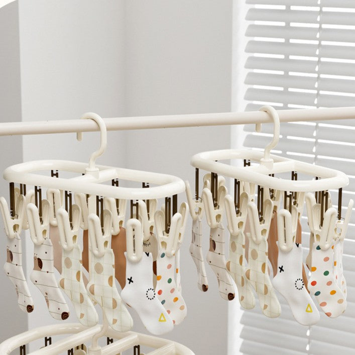 Cream-coloured plastic clothes horse with multiple clips [12 clips]